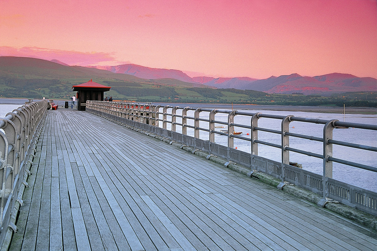 Beaumaris Pier and Snowdonia at sunset